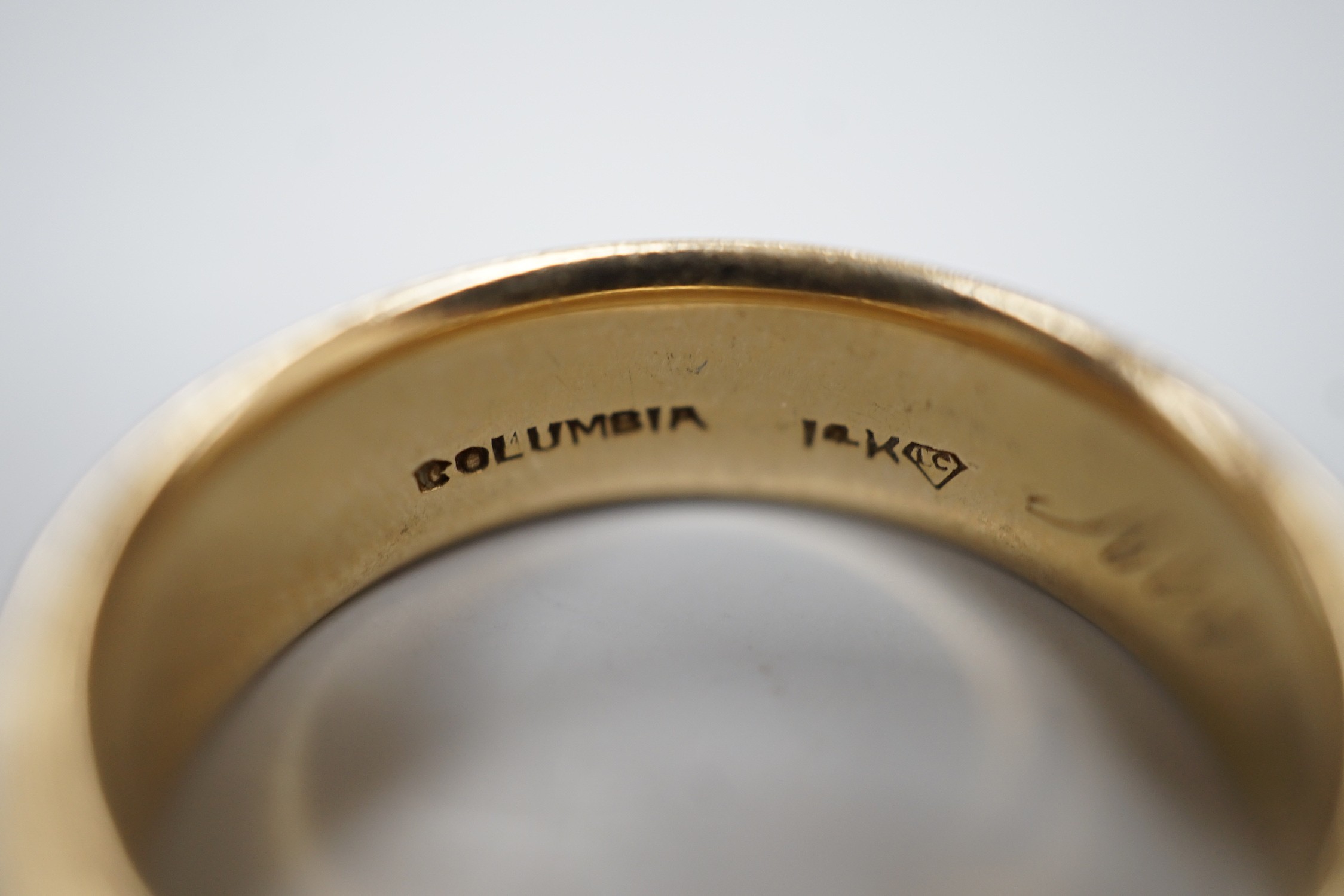 A 14k wedding band, stamped 'Columbia' and inscribed 'All my love Nancy', size U, 11.6 grams.